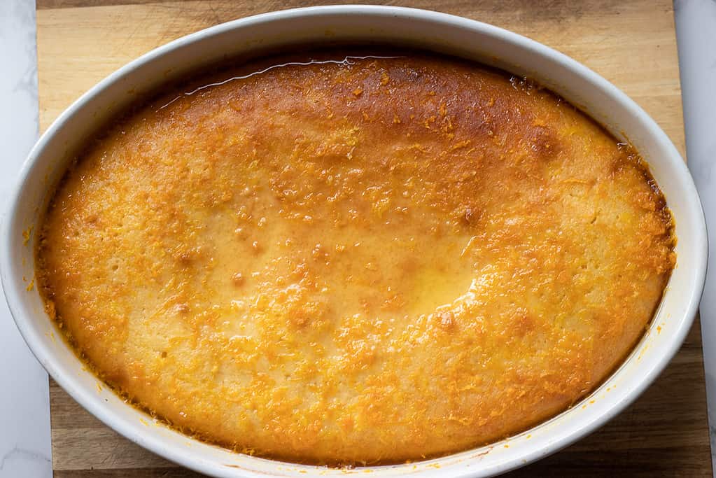 Cooled syrup is poured over the revani cake.