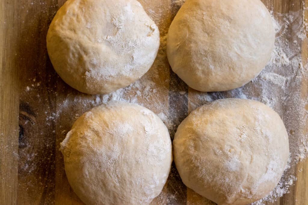 The dough divided into 4 equal pieces.