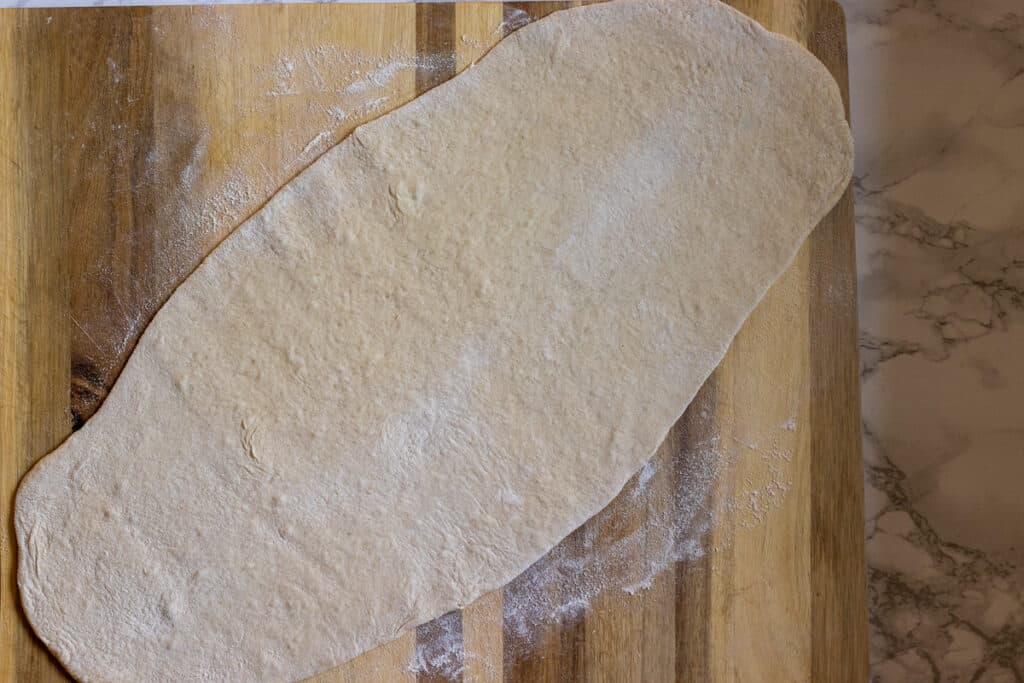 One dough ball rolled out into an oval shape.