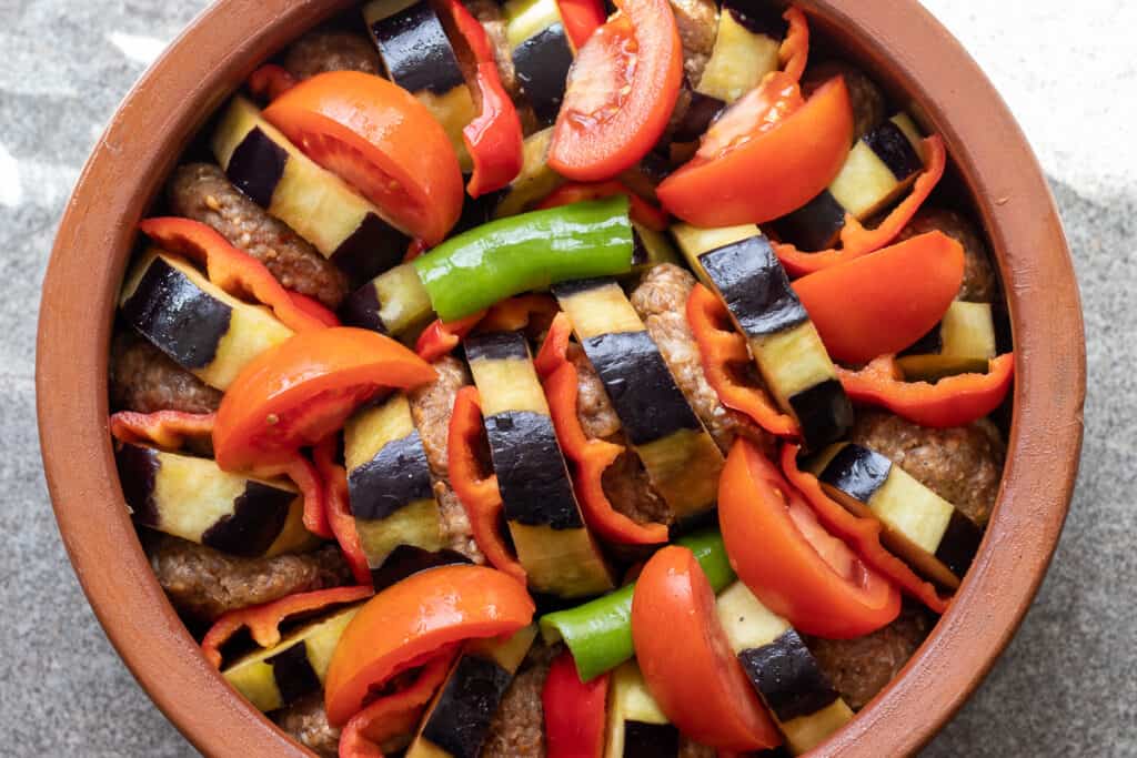 Tomato wedges and peppers added around the meatballs.