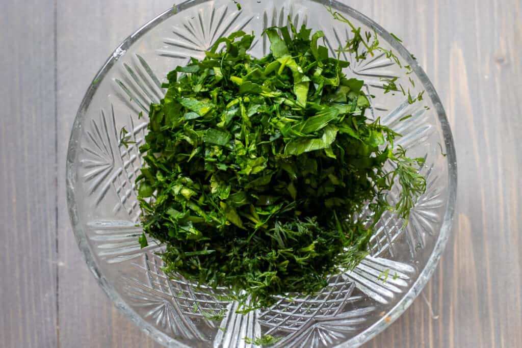 Chopped parsley and dill ready to add to the tartar sauce.