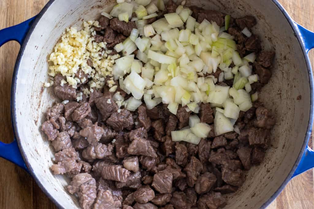 Onions and garlic added to the browned beef.