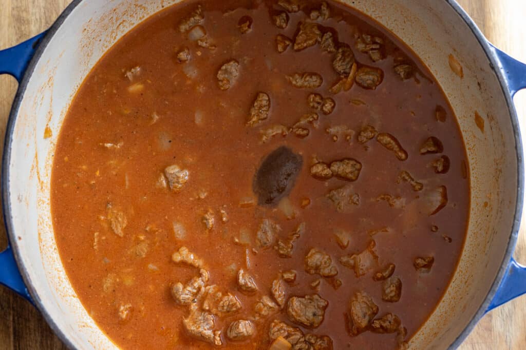 Stock poured in to deglaze the pan.