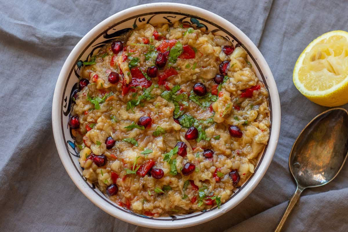 The dip is served with pomegranate seeds and parsley.