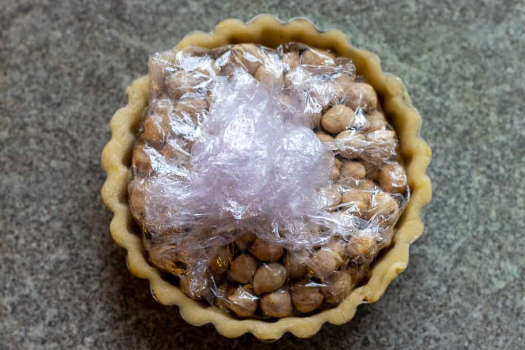 A lined tartlet shell ready for blind baking.
