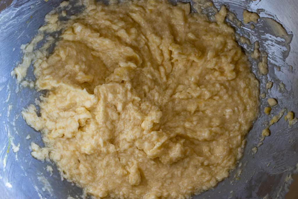 Flour added to the mixture and mixed until it looks like clumpy sand.