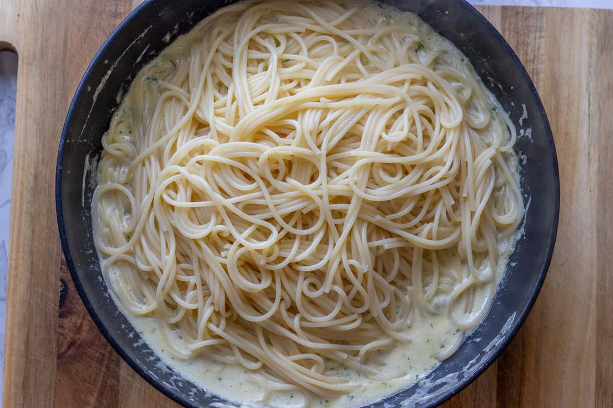 Cooked pasta is added to the pan with
creamy sauce.