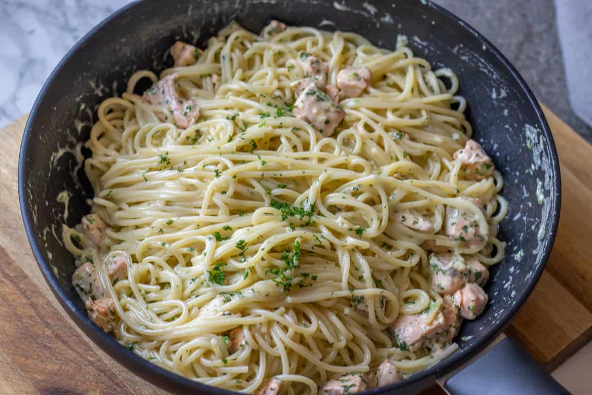 Cooked pasta is tossed with creamy salmon sauce.