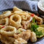 Calamari fritti served with lemon wedges