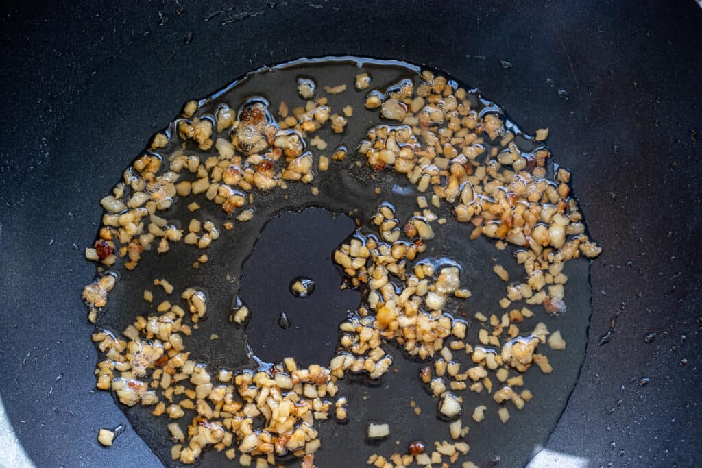 Rendering lamb fat in a wok.