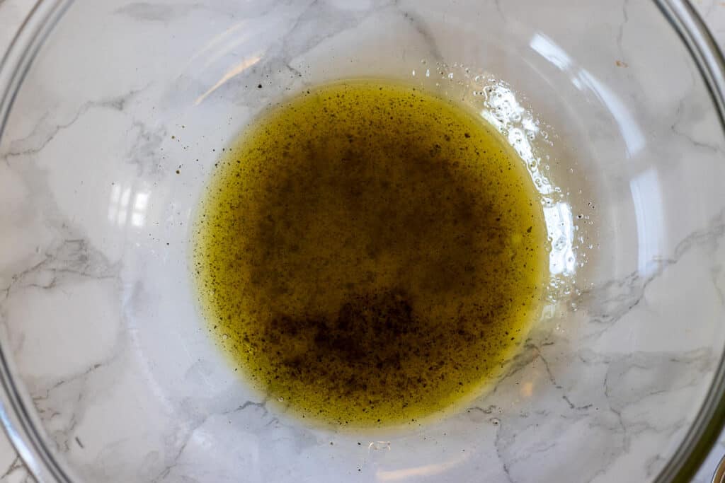 The marinade for cokertme kebabi is mixed in a bowl.