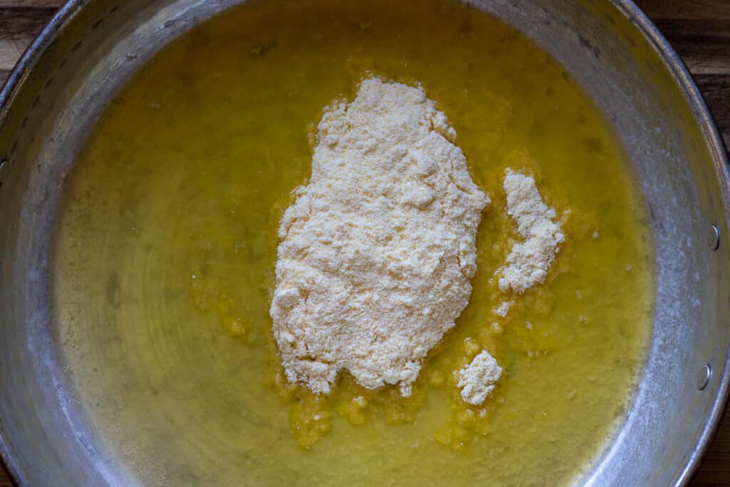 Medium cornmeal added to melted butter for kuymak.