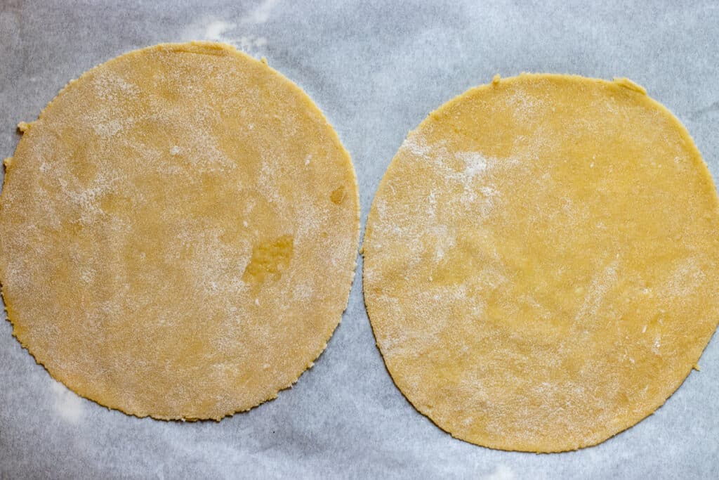 2 dough circles are placed on a baking sheet.