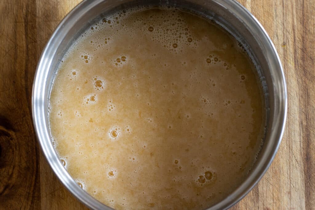 Lightly beaten eggs are added to the melted honey sugar mixture.