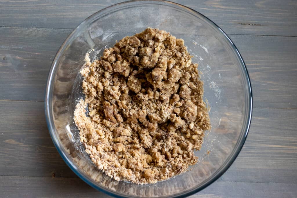 Butter, sugar, cinnamon, and flour are mixed together to form the crumb topping.
