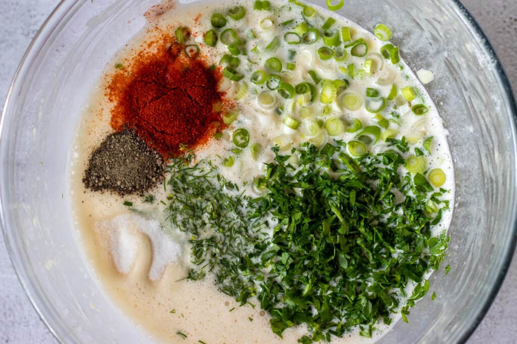 Herbs, cheese, seasoning, and spring onions added to the batter.