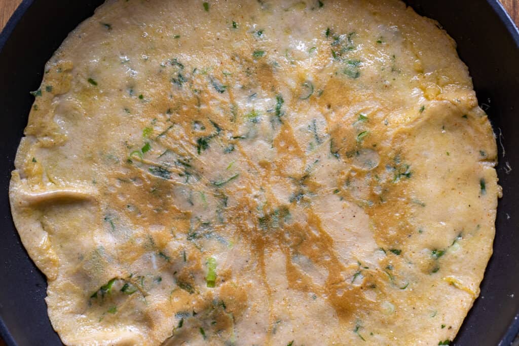The omelette flipped to cook the other side.