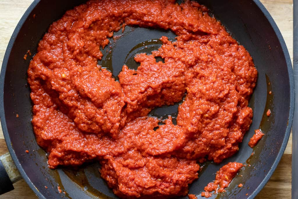 Blitzed roasted red peppers are added to tomato paste and pepper paste.