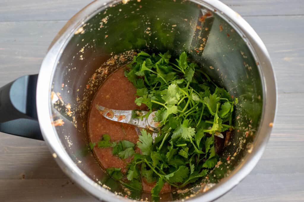 Coriander leaves added to the blitzed dressing.
