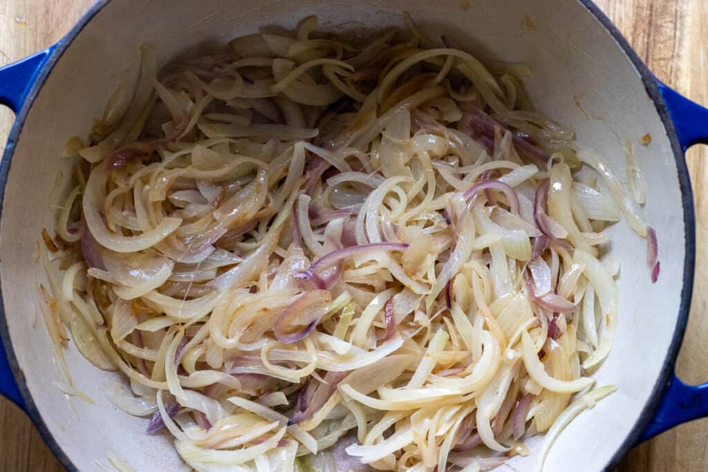 Onions softening in the Dutch oven over low heat.