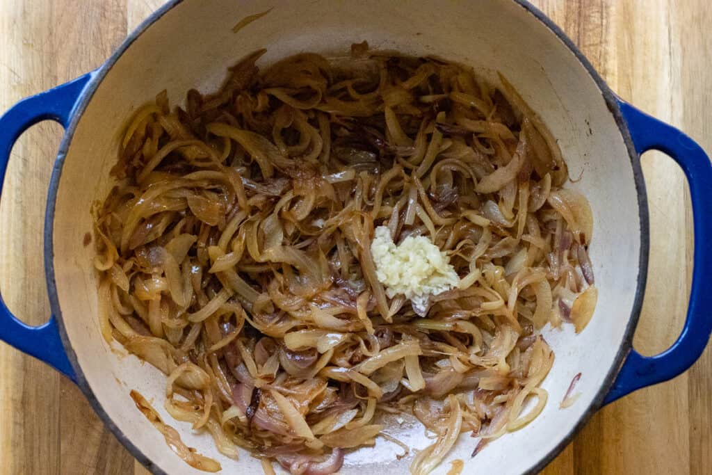 Deeply caramelized onions with minced garlic added to the pot.