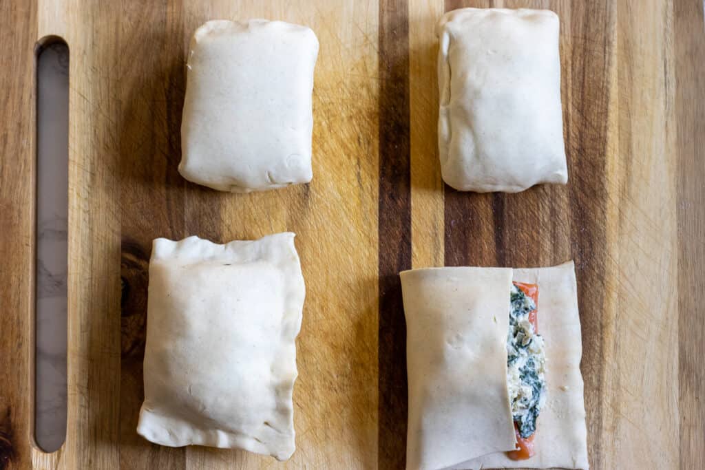 Folding the empty side of the puff pastry over the salmon.
