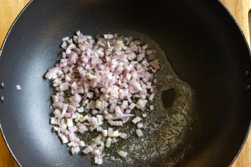 Sautéing the shallots with butter in a pan