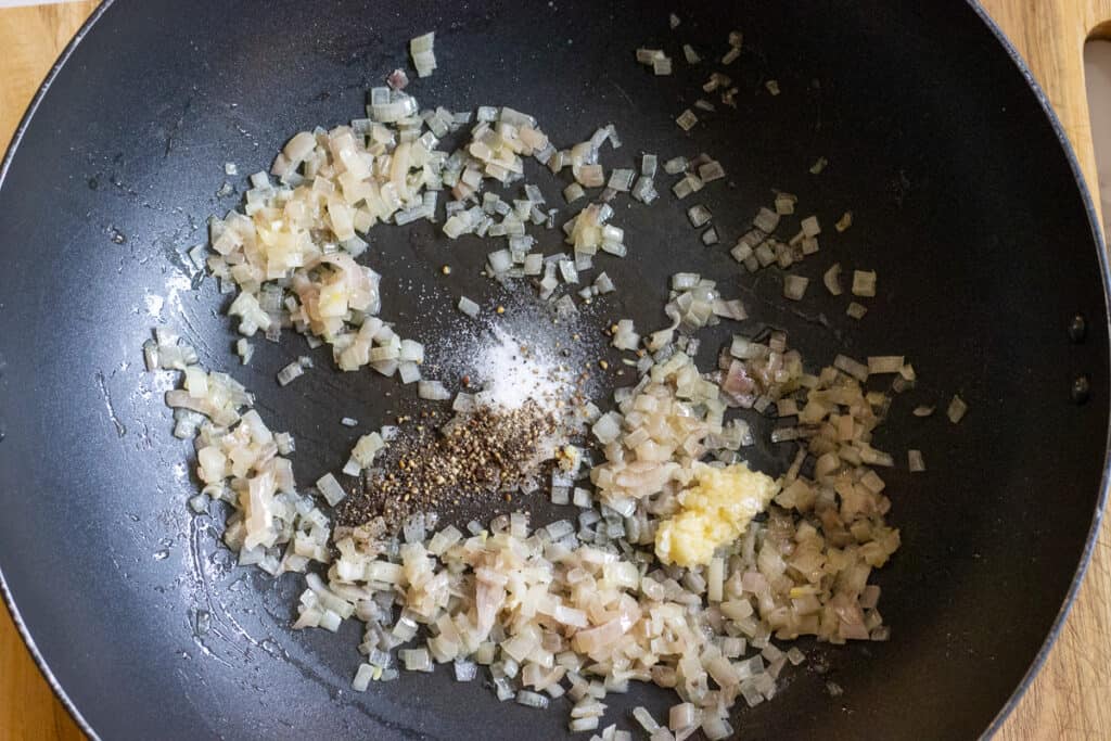 Sautéing the garlic and pepper with onions