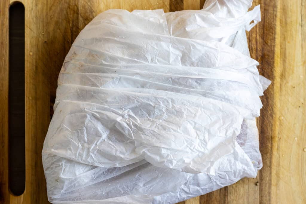 Lamb shoulder wrapped in two layers of parchment paper.