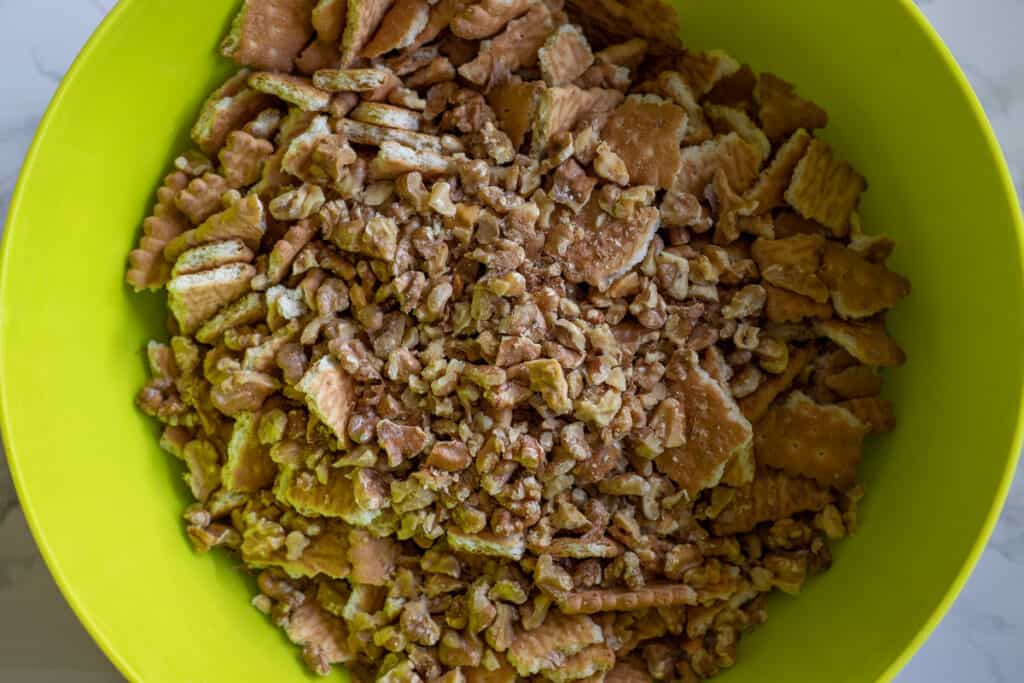 Walnuts are added to the crushed biscuits.