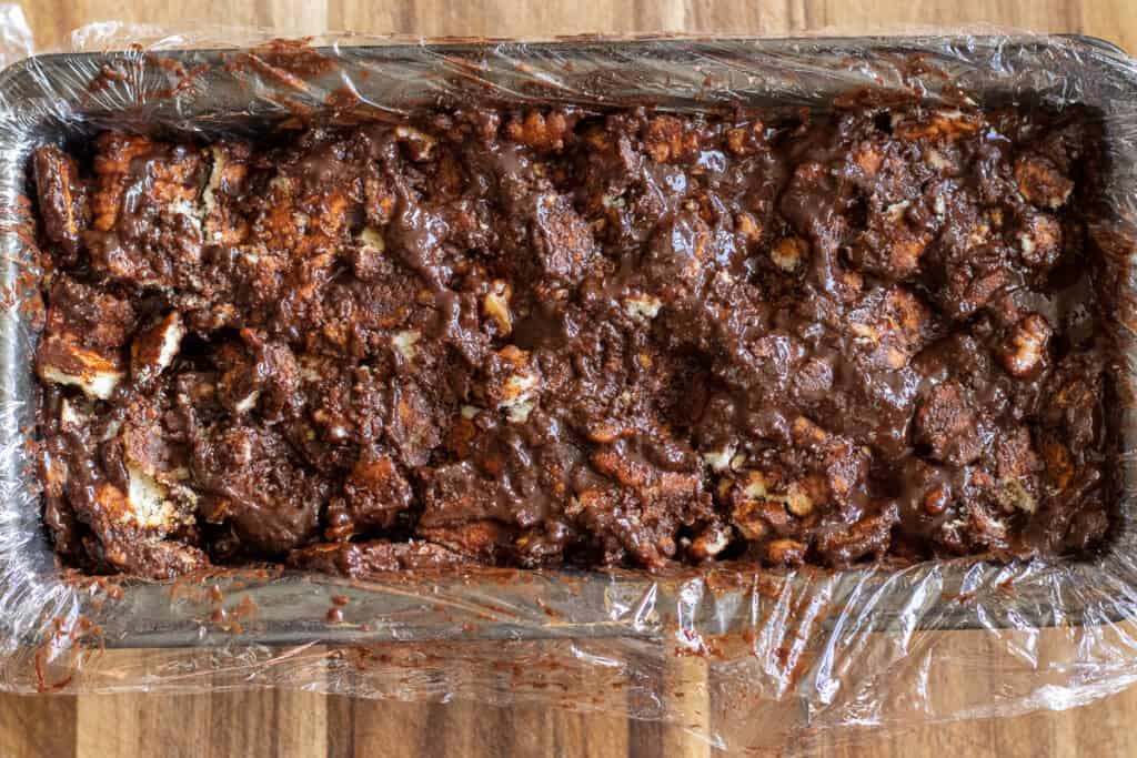 The lazy cake mixture is transferred to a loaf pan.