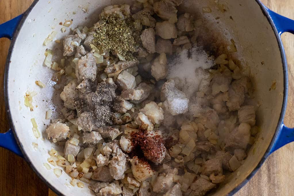 Thyme, salt, pepper, and chili are added to the lamb.