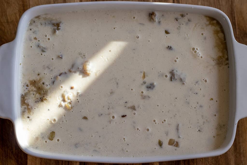 The yogurt topping is poured over the lamb meat.
