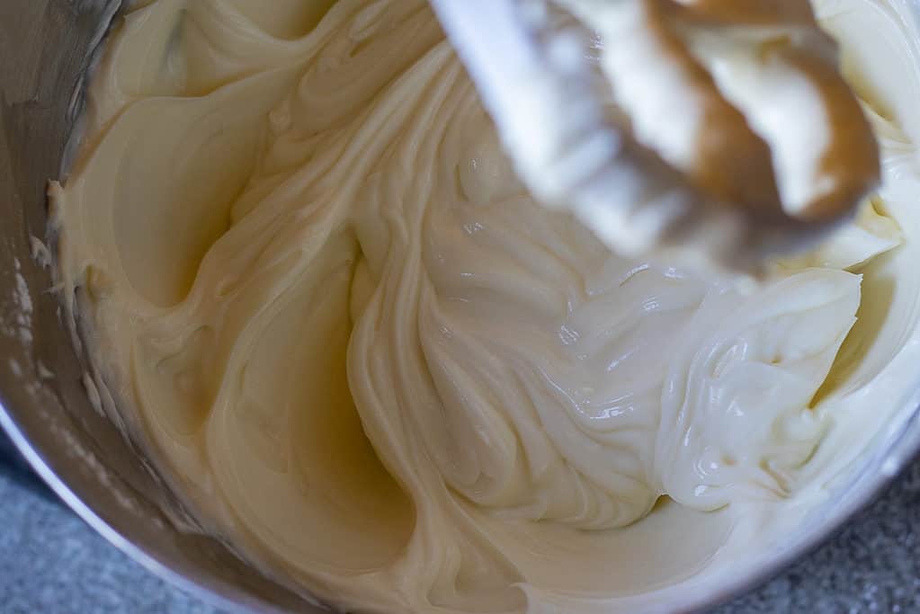 Powdered sugar and cream cheese mixed in a bowl.