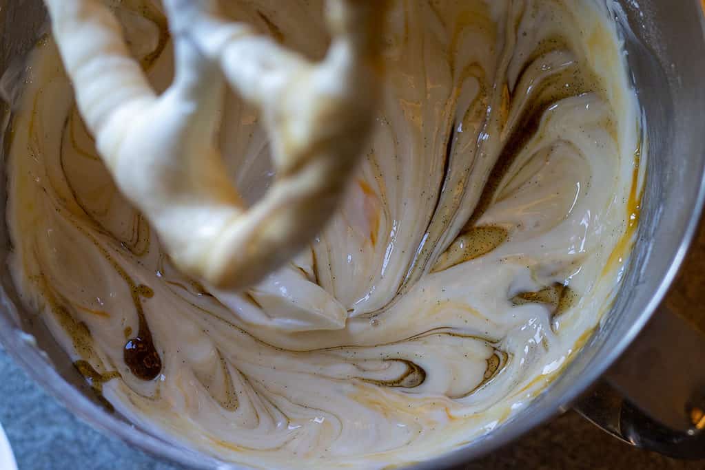 Eggs and vanilla added to the cheesecake mixture.