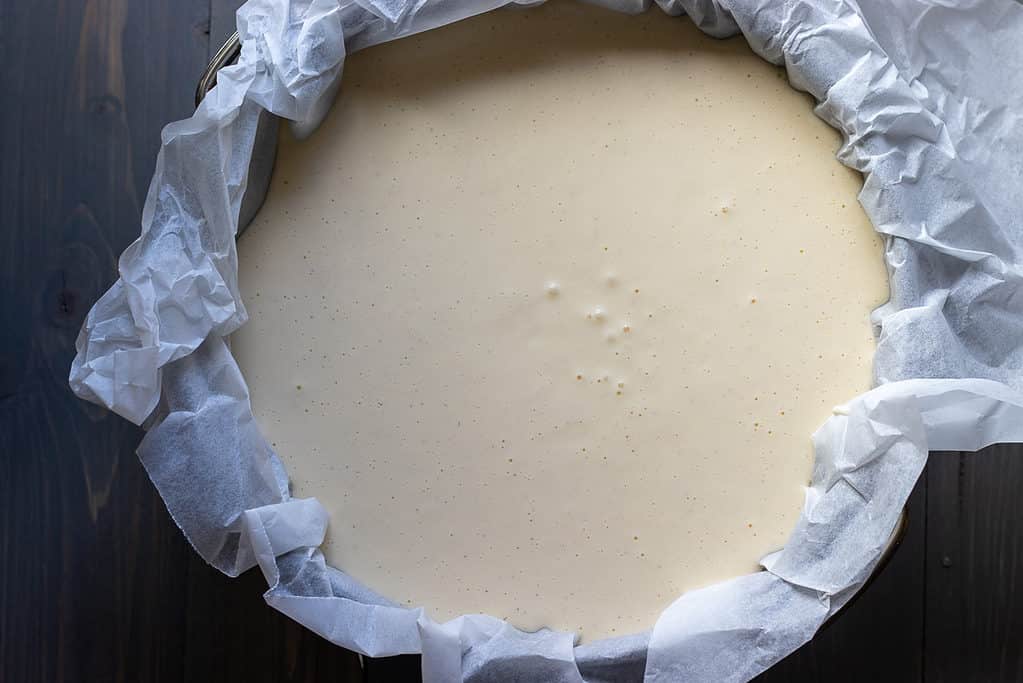 The cheesecake mixture poured into the cake tin.