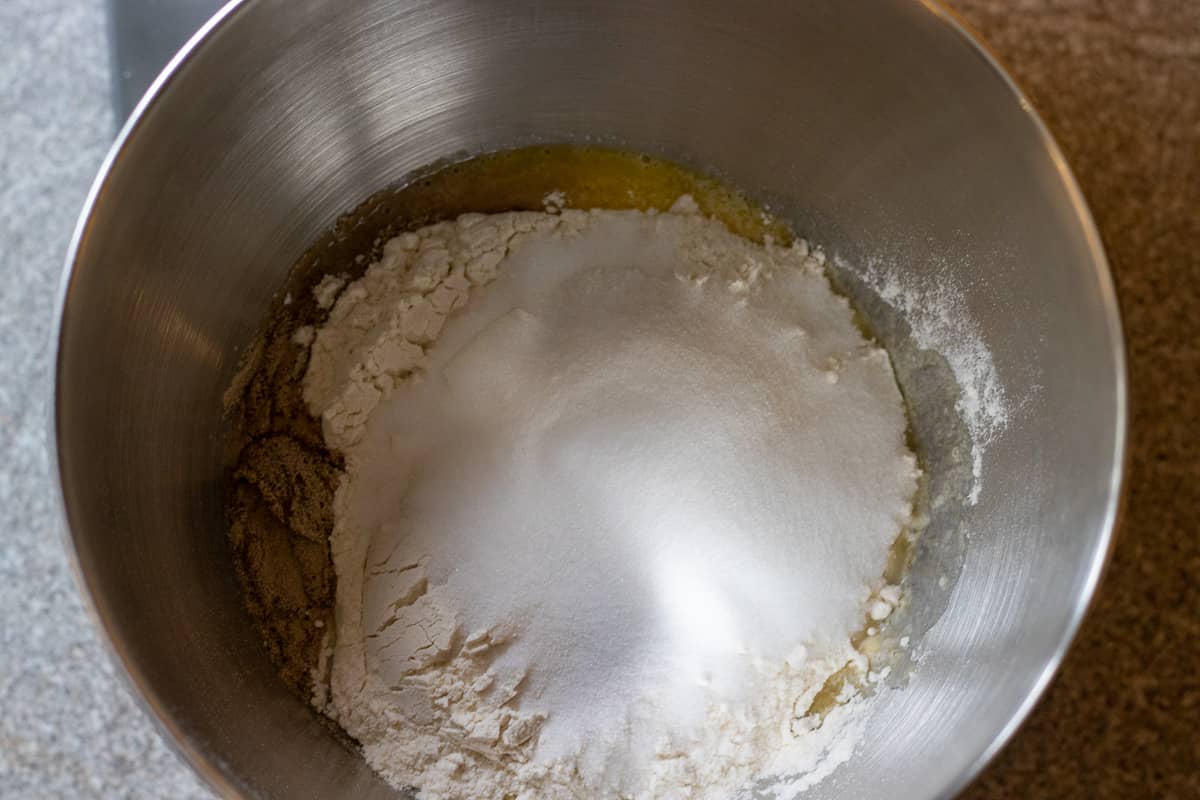 The sugar and flour are added to the mixing bowl.