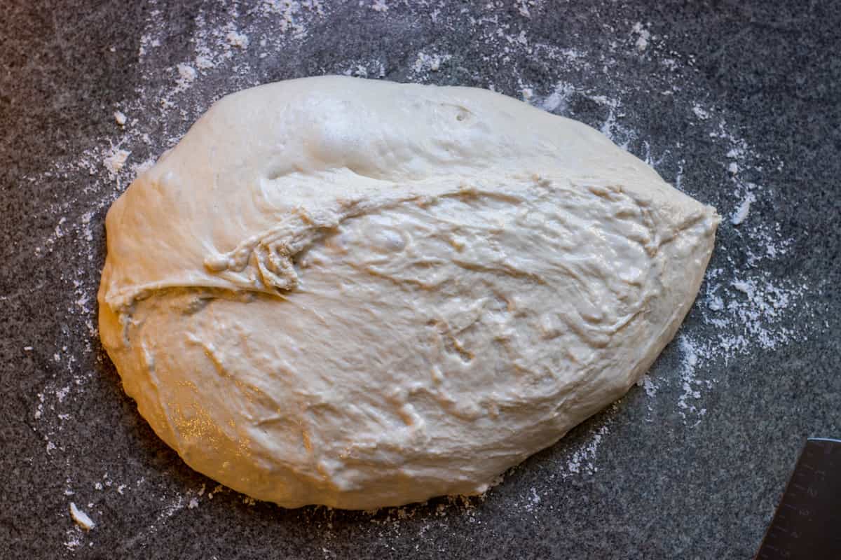 The dough transferred onto a lightly floured surface.