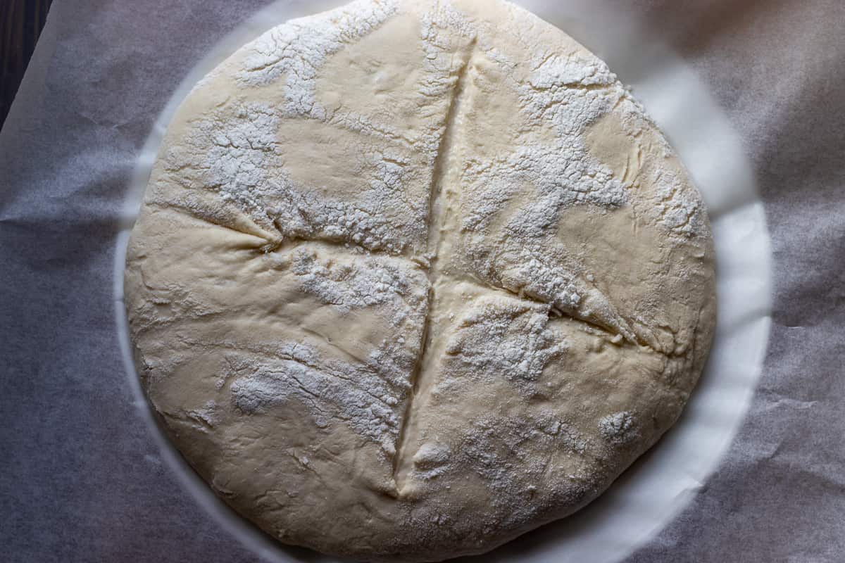 The dough has been scored with a sharp knife.