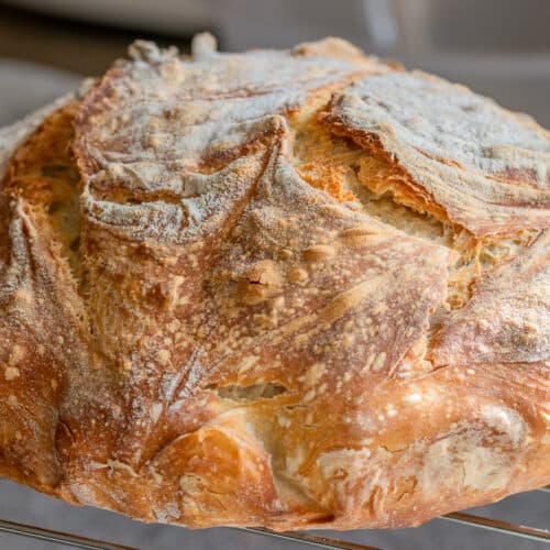freshly baked sourdough bread on a cooling rack
