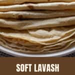 A stack of soft lavash flatbreads on a white plate.