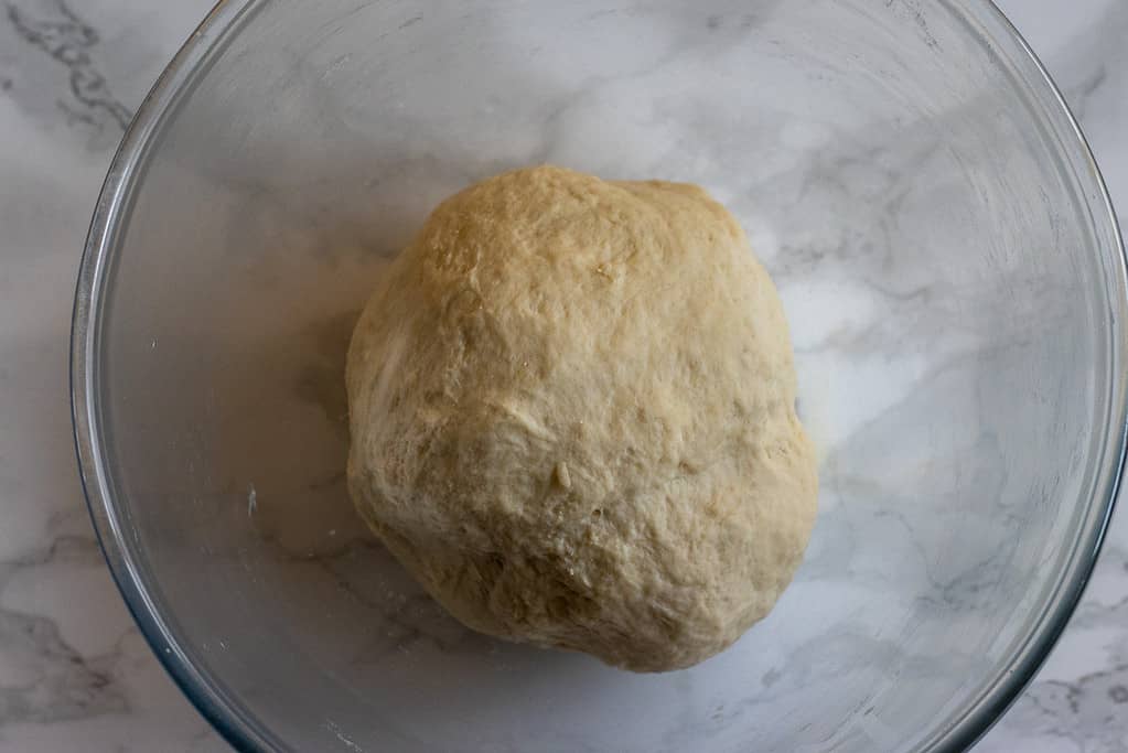 Kneaded manakish dough in a bowl before rising.