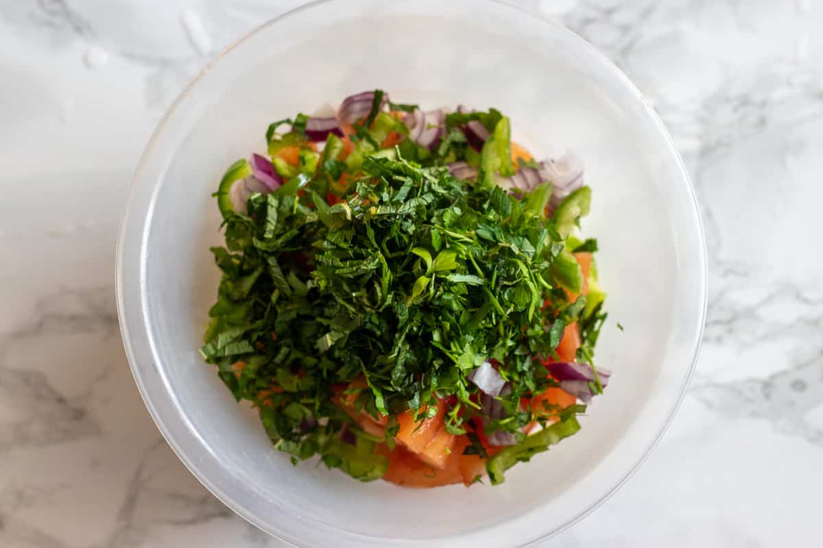Chopped parsley and mint piled on top of the vegetables.