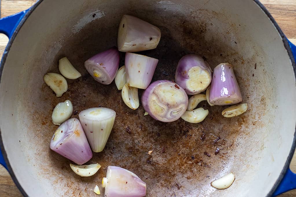 Sautéing the onions and garlic in a Dutch oven.