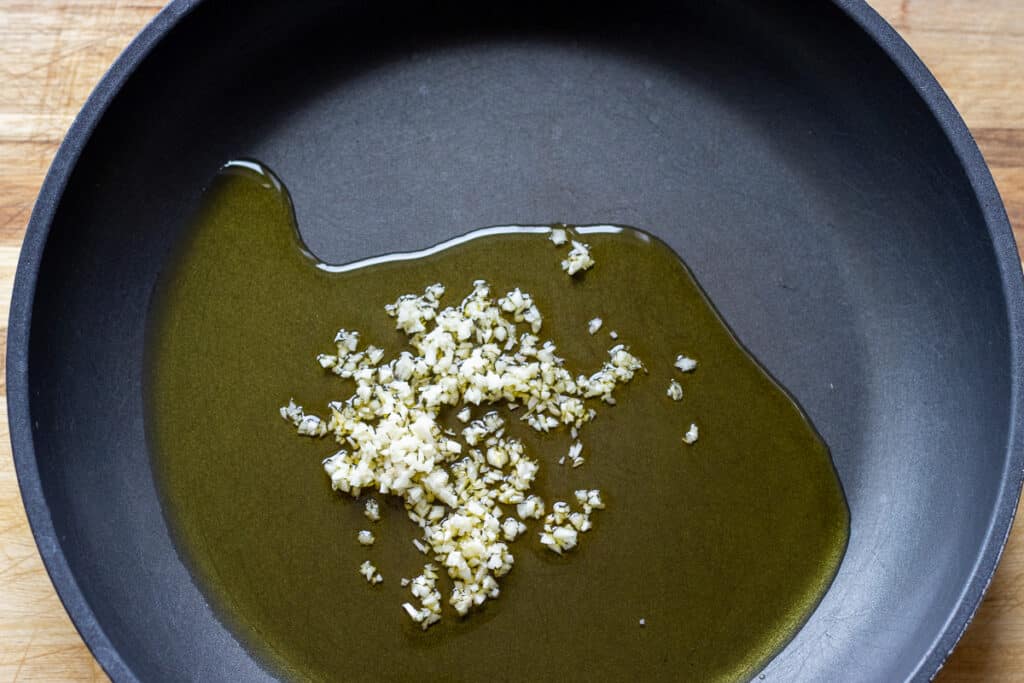 Gently sautéing the garlic with olive oil.