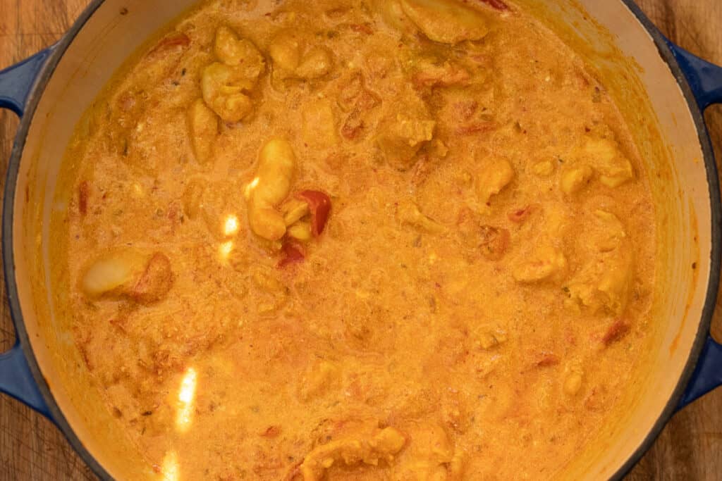 Cream stirred into the chicken handi.