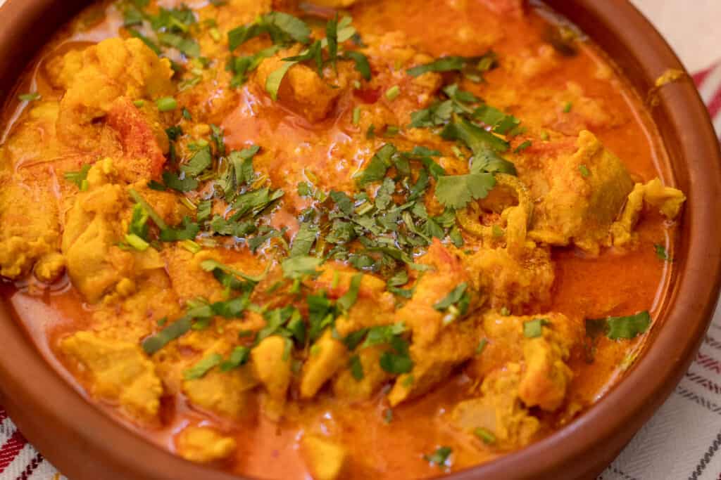 Chicken handi finished with green chili and fresh coriander.