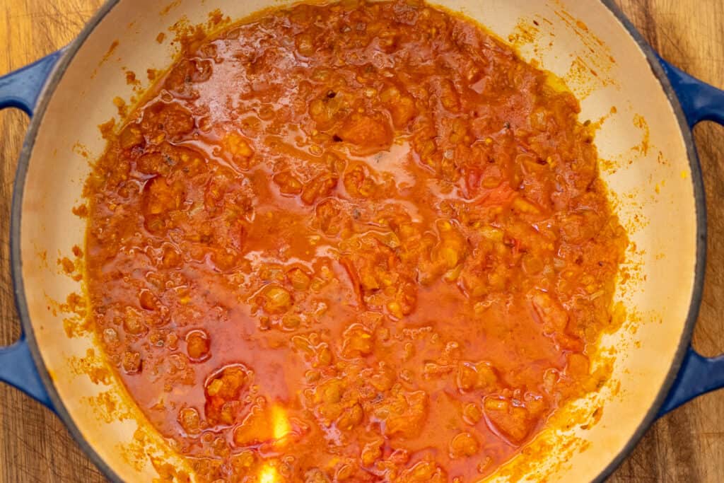Whisked yogurt stirred into the masala on low heat.