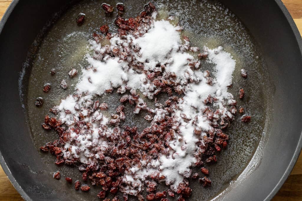Sautéing barberries with butter and sugar.