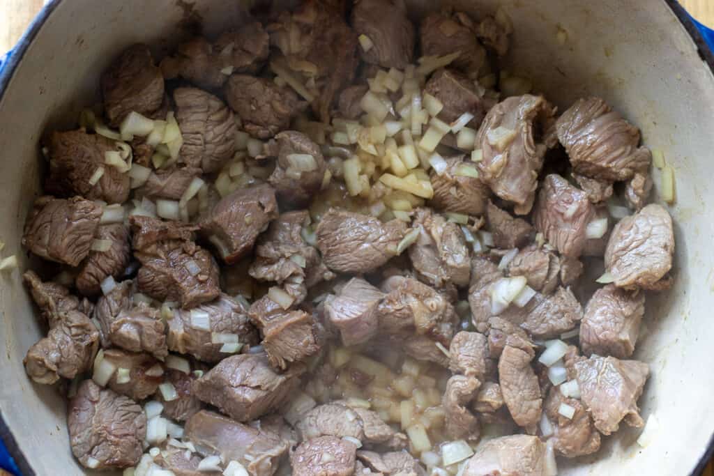 Sautéing the onions with the lamb.